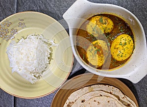 An Indian spread of spicy Egg curry or Egg Masala in a bowl