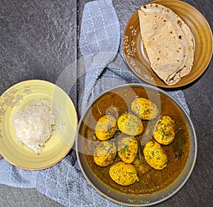 An Indian spread of spicy Egg curry or Egg Masala in a bowl