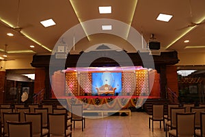 indian stage decoration with flowers and bells