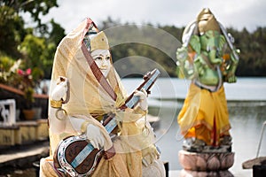 Indian statues on the background of the lake in Mauritius. Grand Bassin.