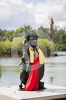 Indian statues on the background of the lake in Mauritius. Grand Bassin.