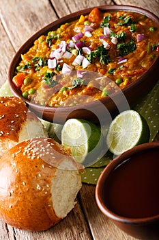 Indian street food Pav bhaji vegetables close-up in a bowl. vert