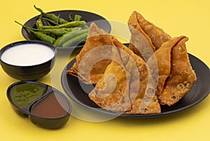 Indian Street Food Samosa or Samosas is a Crispy And Spicy Triangle Shape Snack