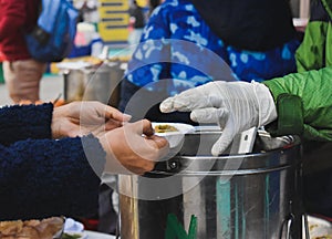 Indian Street food. Vendor serving pani puri in paper plate.