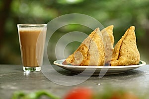 Indian street foods- spicy vegan  samosa with tea,