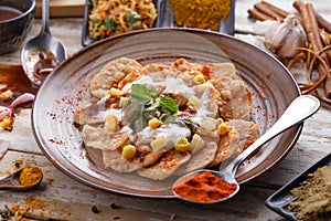 Indian streetfood papri chaat garnished and served with yoghurt