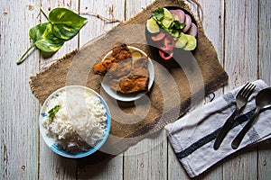 Indian style rice and fried fish with condiments