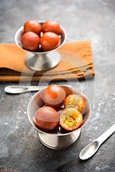 Indian sweet Gulab Jamun served in a ceramic bowl, selective focus