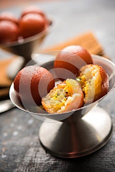 Indian sweet Gulab Jamun served in a ceramic bowl, selective focus