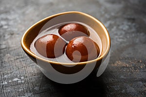 Indian sweet Gulab Jamun served in a ceramic bowl, selective focus