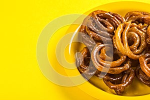 Indian sweet jalebi, indian dessert jalebi or imarti or imarati or jilbi on yellow background