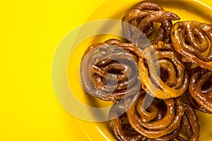 Indian sweet jalebi, indian dessert jalebi or imarti or imarati or jilbi on yellow background