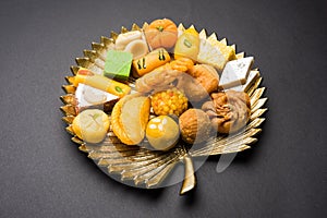 Indian sweets or Mithai for diwali festival with oil lamp or diya and gift box