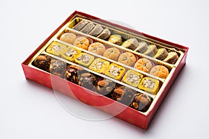 Indian sweets or Mithai for diwali festival with oil lamp or diya and gift box