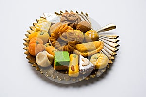 Indian sweets or Mithai for diwali festival with oil lamp or diya and gift box