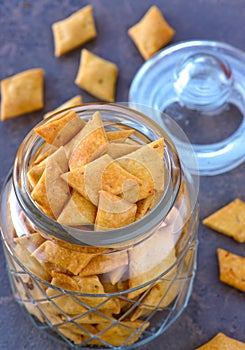 vegan Indian snacks- namak paare salty crackers in a glass jar photo