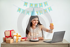 Indian teen girl having online birthday party from home during coronavirus lockdown, video conferencing with friends