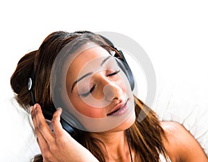 Indian teenage girl, with headphones, eyes closed