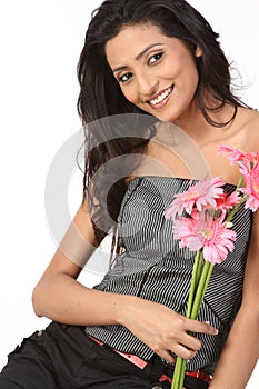 Indian teenage girl with pink daisy flowers