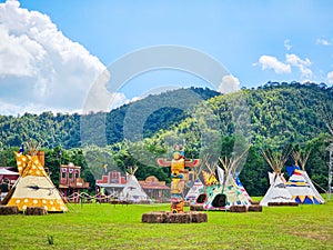 Indian Tent, Teepee Tent, with Wooden totem pole Camping on the field over the blue sky at cowboy concept