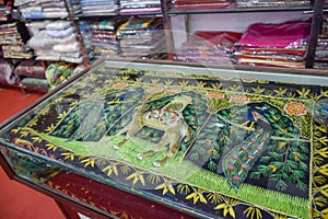 Indian textiles with variety of colors displayed in shop at local market