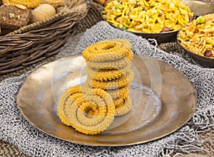 Indian Traditional Deep Fried Snack Chakli on Vintage Background