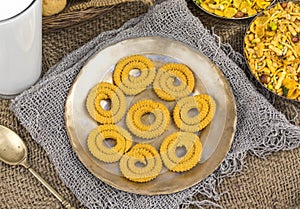 Indian Traditional Deep Fried Snack Chakli on Vintage Background