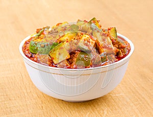 Indian Traditional Raw Mango Pickle on Wooden Background