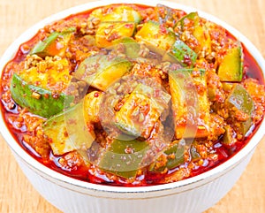 Indian Traditional Raw Mango Pickle on Wooden Background