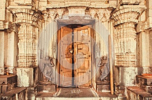 Indian traditional style design at entrance of historical Hindu temple with collumns and sculptures, India