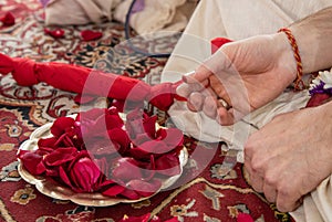 Indian traditional wedding. authentic Vedic wedding ritual called vivaha Yajna. Red Sari, women hands with mehendi close