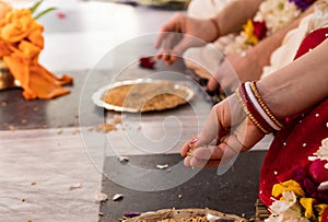 Indian traditional wedding. authentic Vedic wedding ritual called vivaha Yajna. Red Sari, women hands with mehendi close