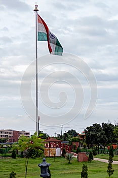 Indian tricolor flag hoisted on a cloudy morning with beautiful sky in the background. Patriotism concept