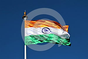 Indian tricolor flag with wheel in blue sky background showing peace