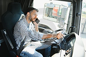 Indian truck driver tending a client on the phone