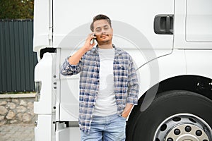 Indian truck driver tending a client on the phone.