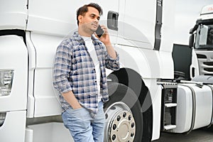 Indian truck driver tending a client on the phone.