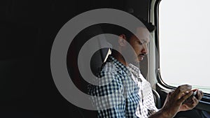 Indian trucker using truck gps navigation to transport and deliver goods to the destination. Black trucker preparing for