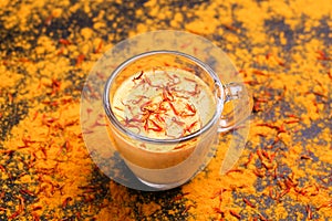 Indian turmeric milk with saffron, cardamom and turmeric. Copyspace