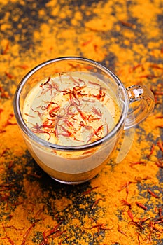 Indian turmeric milk with saffron, cardamom and turmeric. Copyspace