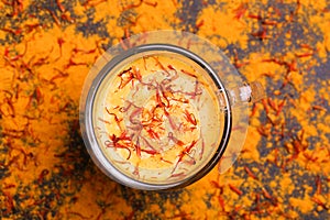 Indian turmeric milk with saffron, cardamom and turmeric. Copyspace