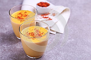 Indian turmeric milk with saffron, cardamom and turmeric. Copyspace