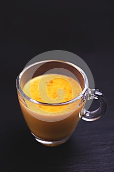 Indian turmeric milk with saffron, cardamom and turmeric. Copyspace