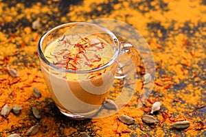 Indian turmeric milk with saffron, cardamom and turmeric. Copyspace