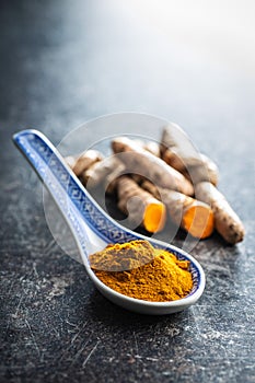 Indian turmeric powder and root. Turmeric spice. Ground turmeric