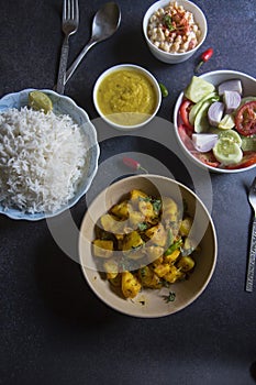 ndian veg lunch rumali roti or Indian bread and alu jeera or potato masala served