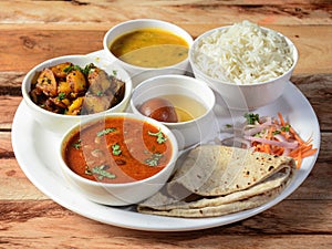 Indian Veg Rajma Thali / food platter consists variety of veggies, lentils, sweet dish, snacks etc., selective focus