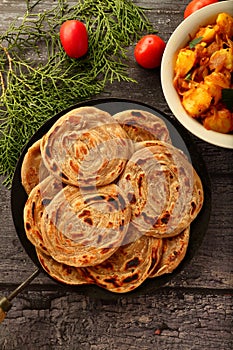 Indian vegan food recipes- wheat paratha with dum aloo.