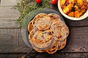 Indian vegan food recipes- wheat paratha with dum aloo.