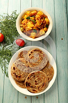 Indian vegan food recipes- wheat paratha  served with curry
